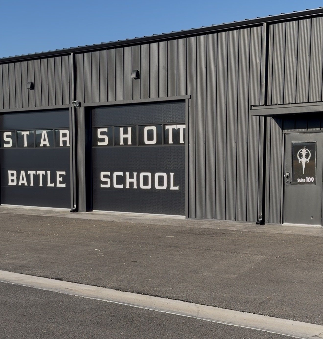 Starshott Battle School storefront: STARSHOTT garage doors and the Suite 109 door